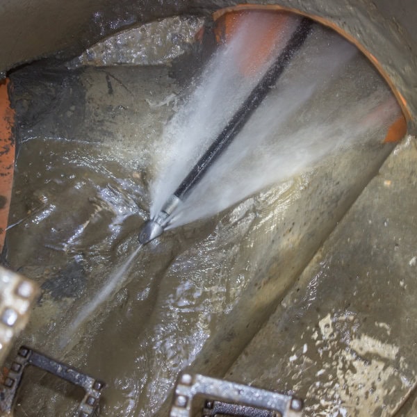 A blocked drain being jetted by a drain engineer