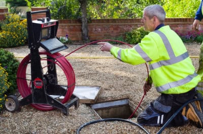 A drain engineer finishing off a drain unblocking job